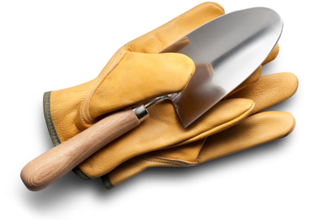 A pair of brown gloves with a hand trowel