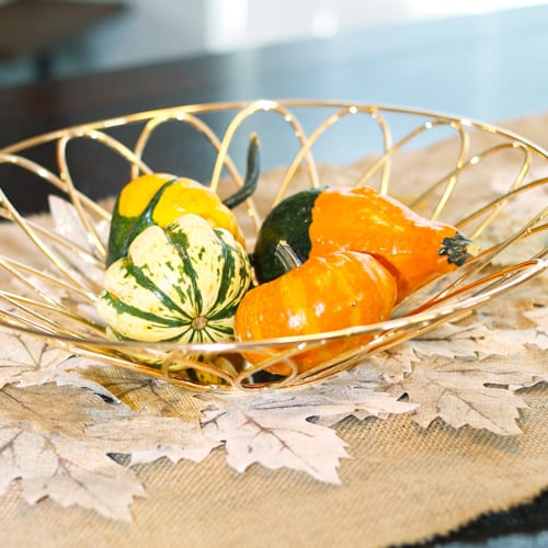 ornamental gourds in gold bowl